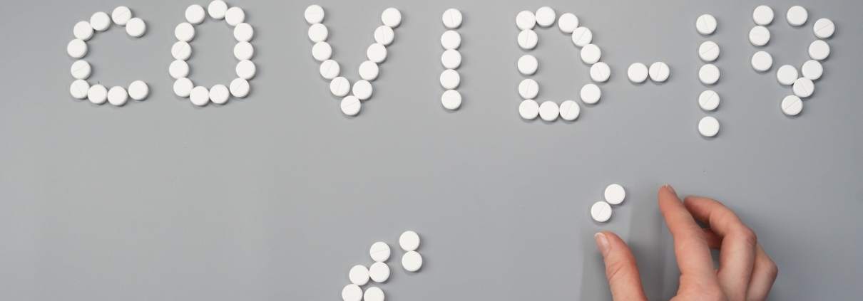 Pills spelling out COVID-19