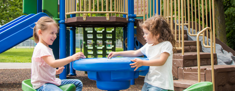 Children playing at a kids table on the playground