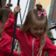 Two girls playing on a playground rope structure