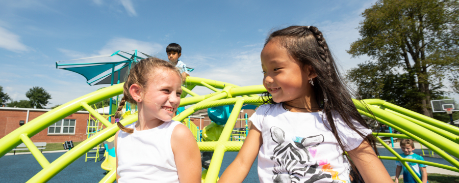 Children playing on a climber at a school playground