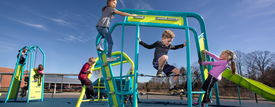 Children playing on Miracle's Champions Trek obstacle course
